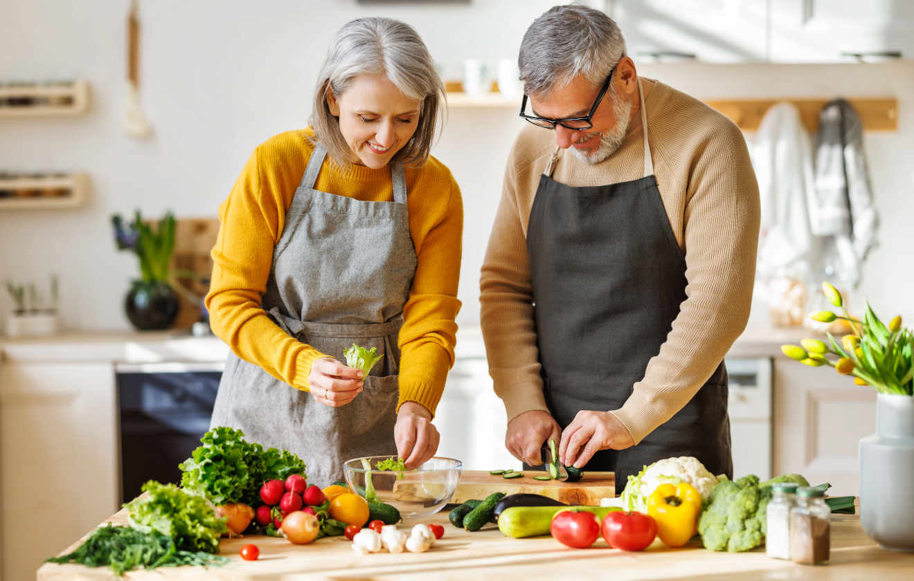 An old couple cooking in kitchen